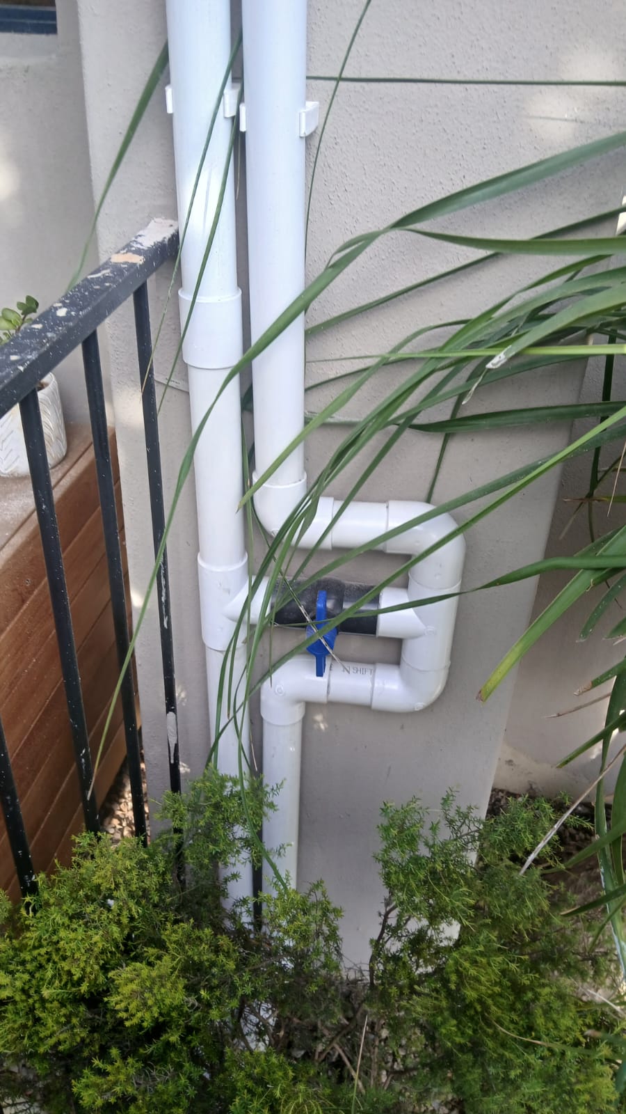 Pool heating pipework on an exterior wall